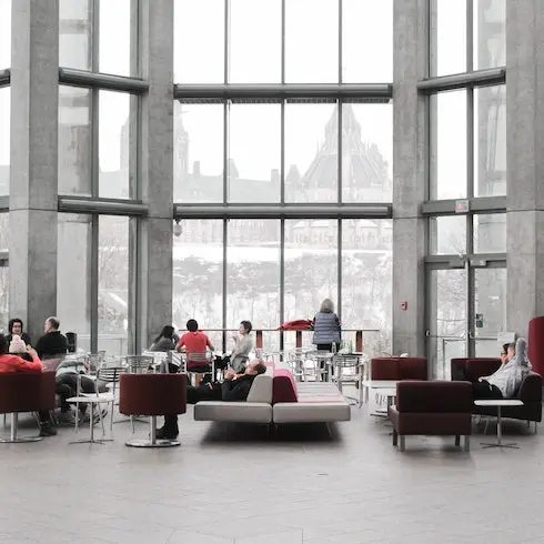 a building lobby with people chatting